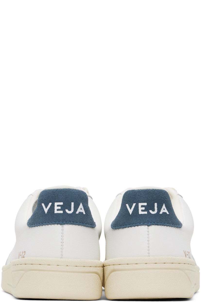 Low-top Organic Traced grained leather sneakers in white and navy.

· Lace-up closure
· Logo printed at padded tongue
· Padded collar
· Logo stitched at sides
· Logo stamp at outer side
· Logo printed at suede heel tab
· Recycled polyester jersey lining
· Treaded rubber sole

Supplier color: Extra white/California