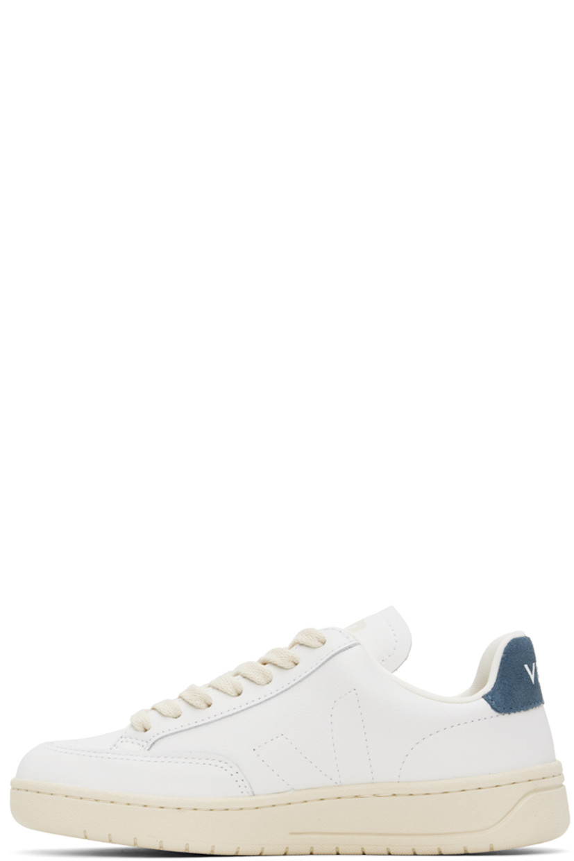 Low-top Organic Traced grained leather sneakers in white and navy.

· Lace-up closure
· Logo printed at padded tongue
· Padded collar
· Logo stitched at sides
· Logo stamp at outer side
· Logo printed at suede heel tab
· Recycled polyester jersey lining
· Treaded rubber sole

Supplier color: Extra white/California