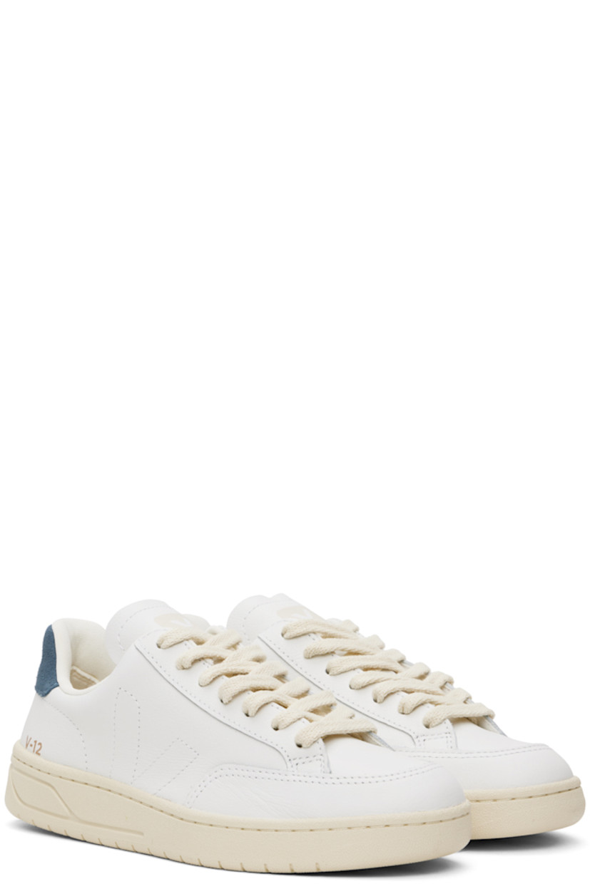 Low-top Organic Traced grained leather sneakers in white and navy.

· Lace-up closure
· Logo printed at padded tongue
· Padded collar
· Logo stitched at sides
· Logo stamp at outer side
· Logo printed at suede heel tab
· Recycled polyester jersey lining
· Treaded rubber sole

Supplier color: Extra white/California