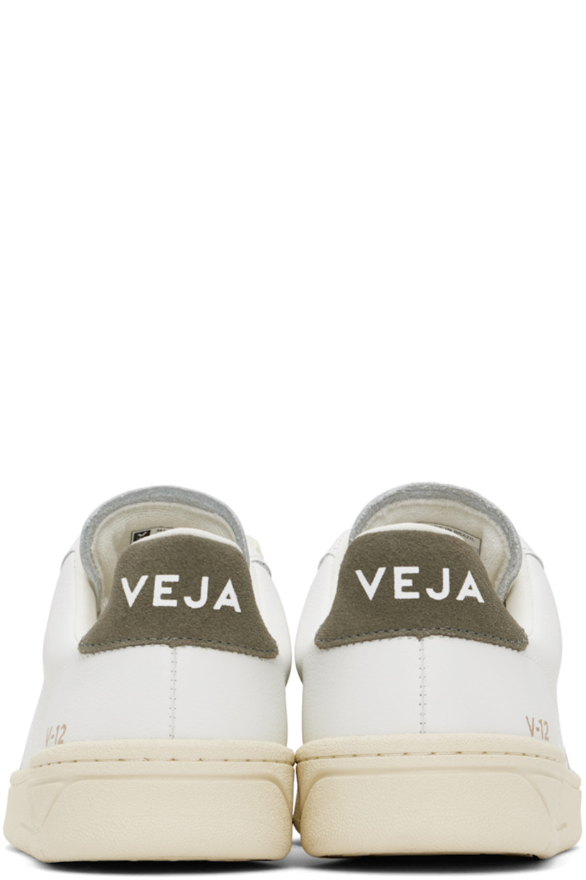 Low-top Organic Traced grained leather sneakers in white and khaki.

· Lace-up closure
· Logo printed at padded tongue
· Padded collar
· Logo stitched at sides
· Logo stamp at outer side
· Logo printed at suede heel tab
· Recycled polyester jersey lining
· Treaded rubber sole

Supplier color: Extra white/Khaki