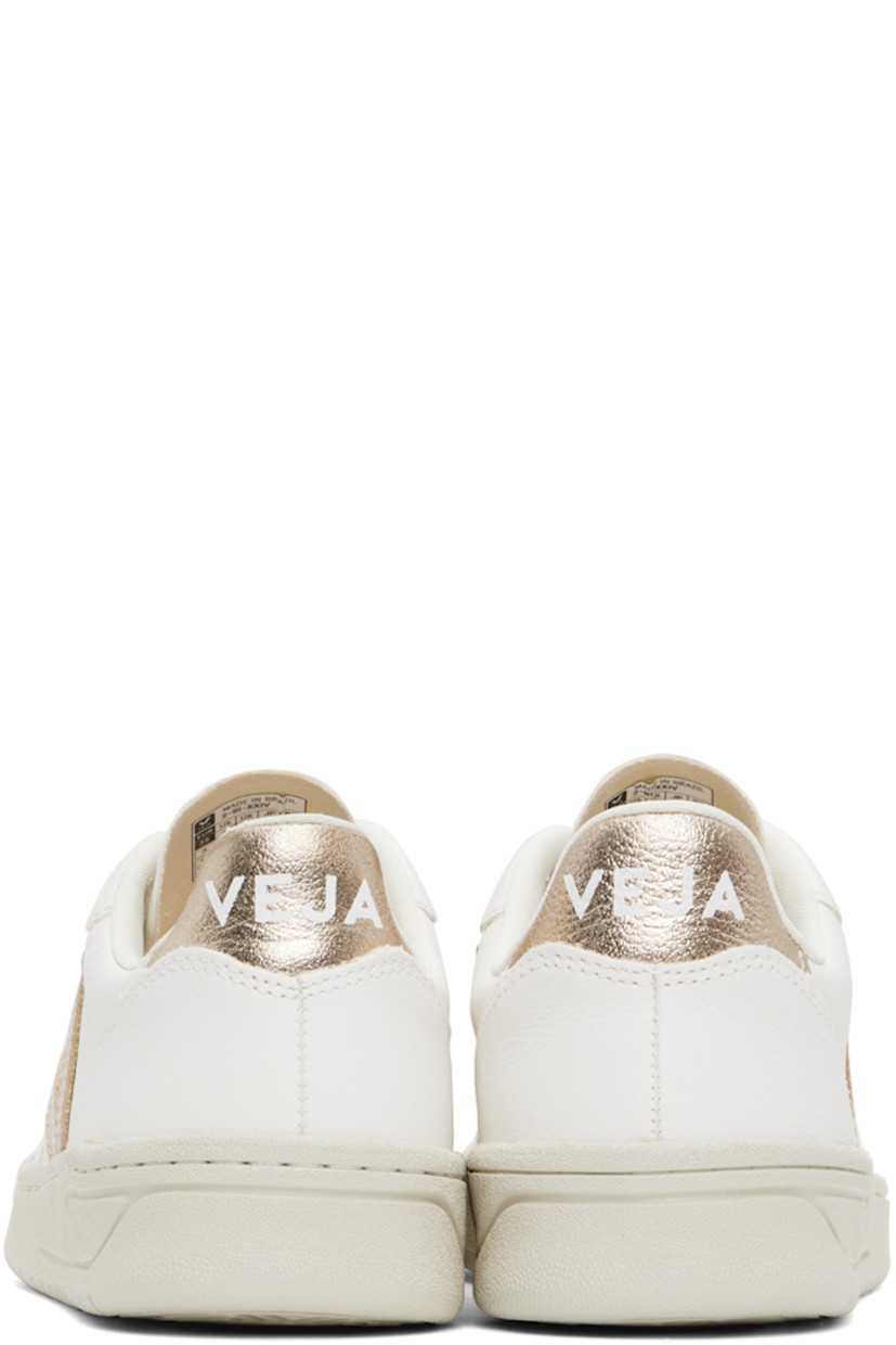 Low-top grained ChromeFree leather sneakers in white and rose gold tone.

· Perforated detailing at toe
· Lace-up closure
· Logo embossed at tongue
· Padded collar
· Logo appliqué at sides 
· Logo printed at heel tab
· Mesh lining
· Treaded rubber sole

Supplier color: Extra white/Platine