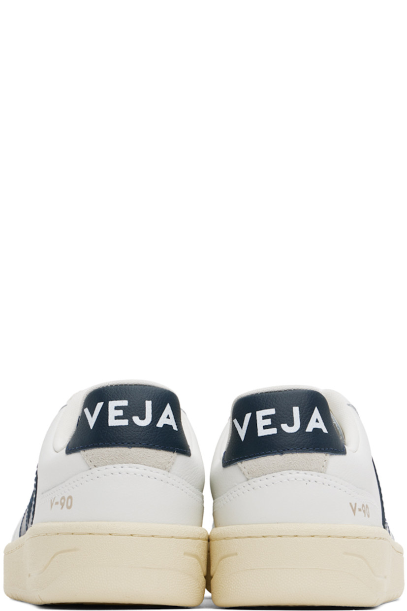 Low-top grained Organic Traced leather sneakers in white and navy.

· Perforated detailing at toe
· Organic cotton lace-up closure
· Logo printed at padded tongue
· Padded collar
· Rubberized logo appliqué at sides
· Gold-tone text printed at outer side
· Logo printed at heel tab
· Suede trim at heel counter
· Jersey lining
· Treaded rubber sole

Supplier color: White/Nautico