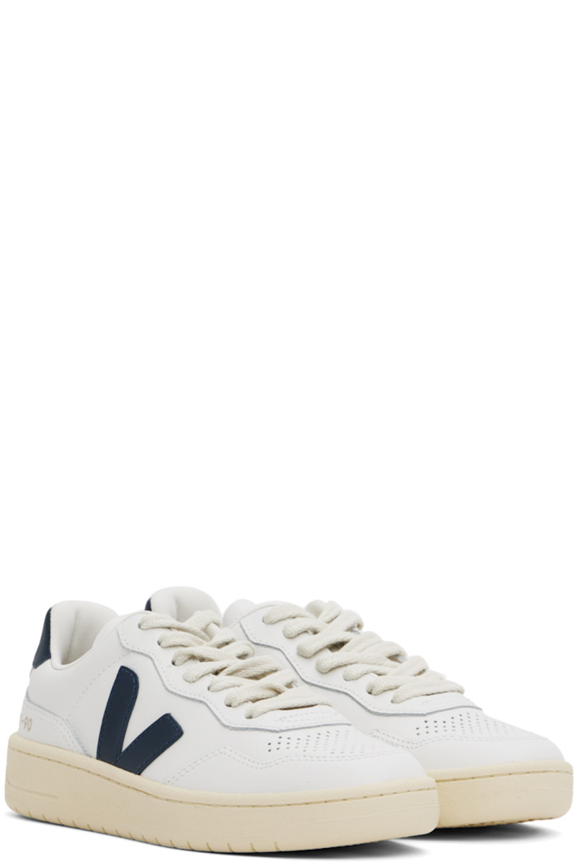 Low-top grained Organic Traced leather sneakers in white and navy.

· Perforated detailing at toe
· Organic cotton lace-up closure
· Logo printed at padded tongue
· Padded collar
· Rubberized logo appliqué at sides
· Gold-tone text printed at outer side
· Logo printed at heel tab
· Suede trim at heel counter
· Jersey lining
· Treaded rubber sole

Supplier color: White/Nautico