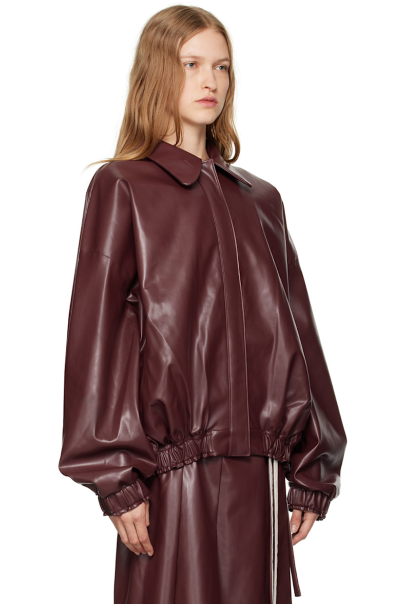 Grained faux-leather jacket. 

· Peter Pan collar
· Buttonhole at collar
· Zip closure
· Welt pockets
· Elasticized hem and cuffs
· Full plain-woven lining

Supplier color: Red leather