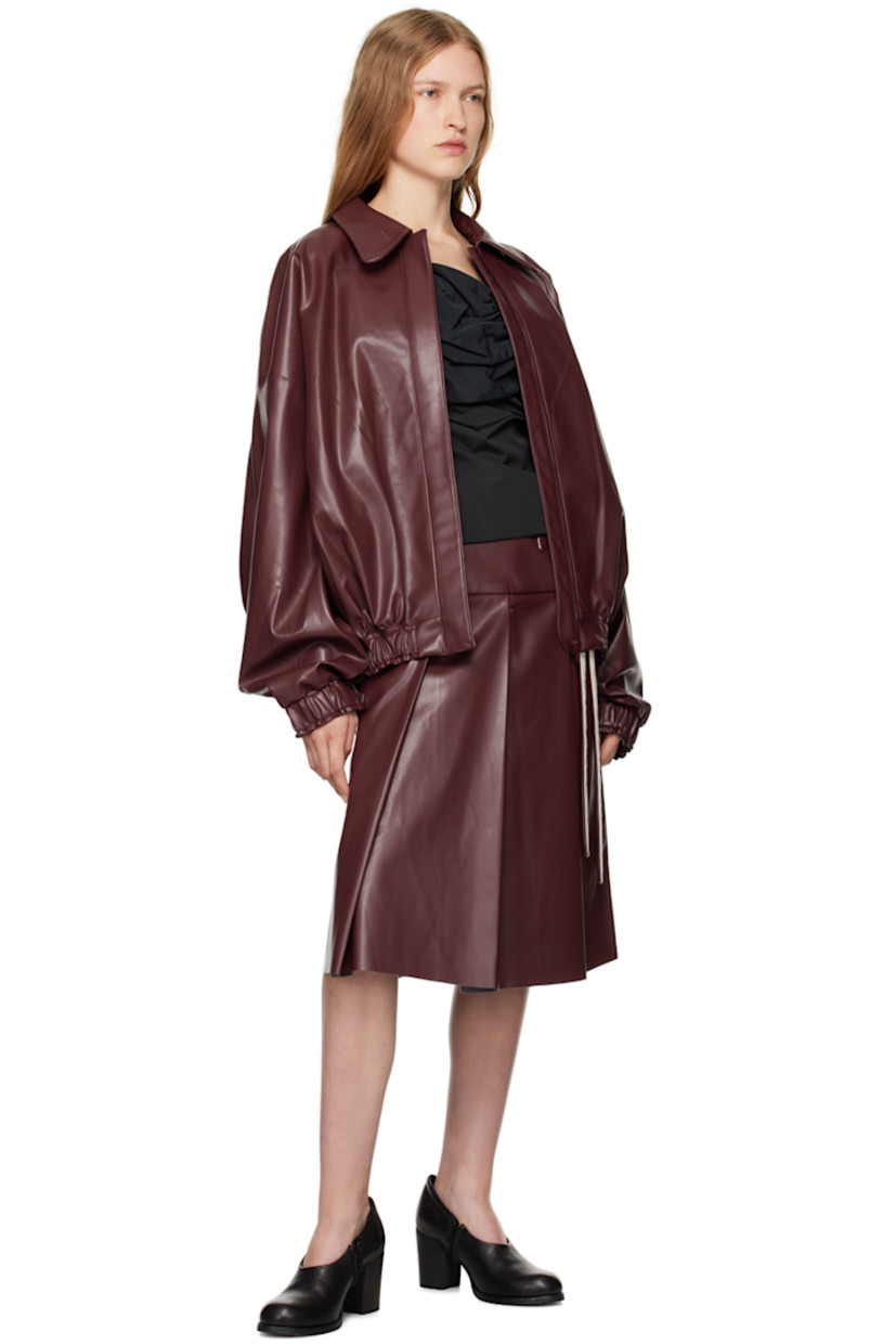 Grained faux-leather jacket. 

· Peter Pan collar
· Buttonhole at collar
· Zip closure
· Welt pockets
· Elasticized hem and cuffs
· Full plain-woven lining

Supplier color: Red leather