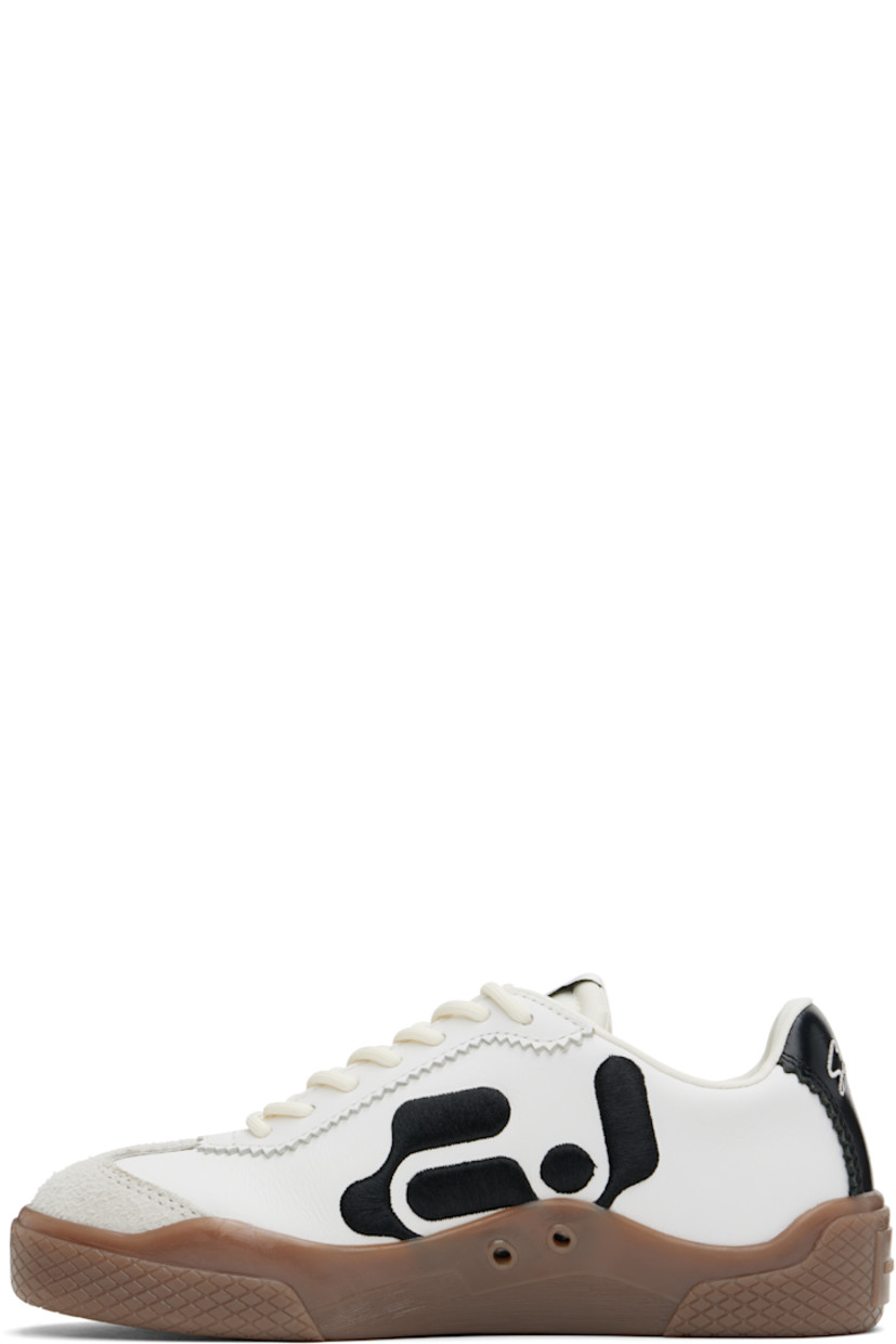 Low-top nappa leather, suede, and canvas sneakers in off-white.

· Serrated detailing throughout
· Lace-up closure
· Logo patch at padded tongue
· Padded collar
· Logo graphic embroidered at sides
· Text embroidered at heel
· Buffed faux-leather lining
· Treaded rubber sole

Supplier color: Swan