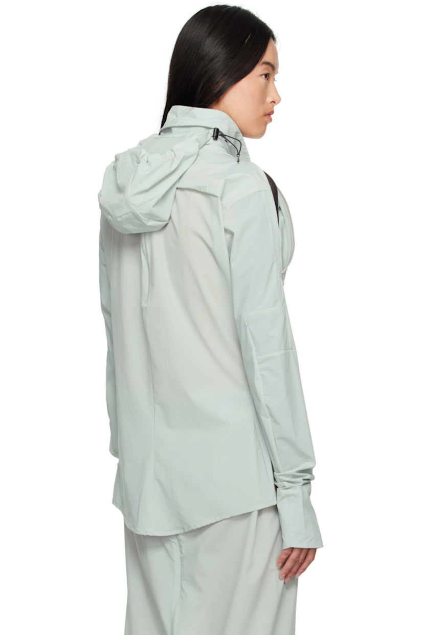 Stretch recycled nylon taffeta shirt.

· Bungee-style drawstring at stowaway hood
· Spread collar
· Button closure
· Shirttail hem
· Zip vent at shoulders
· Thumbhole at cuffs
· Zip vent at back yoke

Supplier color: Mint