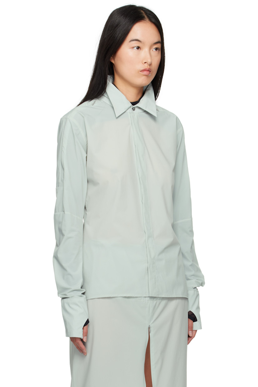 Stretch recycled nylon taffeta shirt.

· Bungee-style drawstring at stowaway hood
· Spread collar
· Button closure
· Shirttail hem
· Zip vent at shoulders
· Thumbhole at cuffs
· Zip vent at back yoke

Supplier color: Mint
