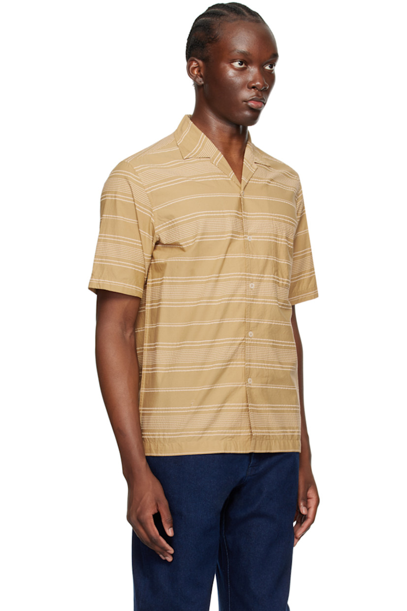 Cotton seersucker shirt. Stripes throughout.

· Open spread collar
· Button closure
· Patch pocket 
· Tennis-tail hem

Supplier color: Sand