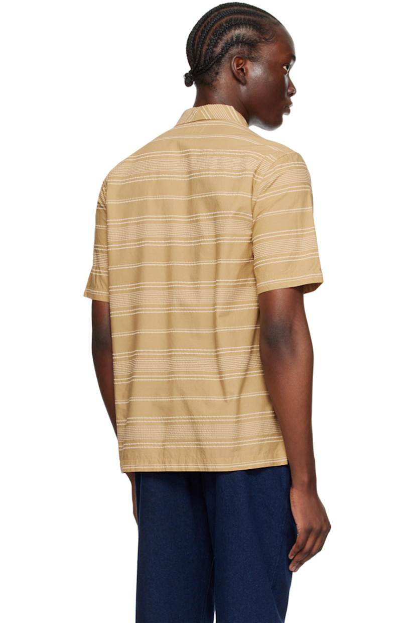Cotton seersucker shirt. Stripes throughout.

· Open spread collar
· Button closure
· Patch pocket 
· Tennis-tail hem

Supplier color: Sand