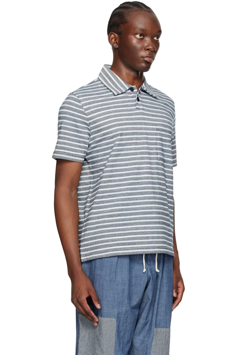 Knit and purl knit cotton polo. Jacquard stripes throughout.

· Spread collar
· Two-button placket
· Patch pocket 
· Vented side seams

Supplier color: Indigo