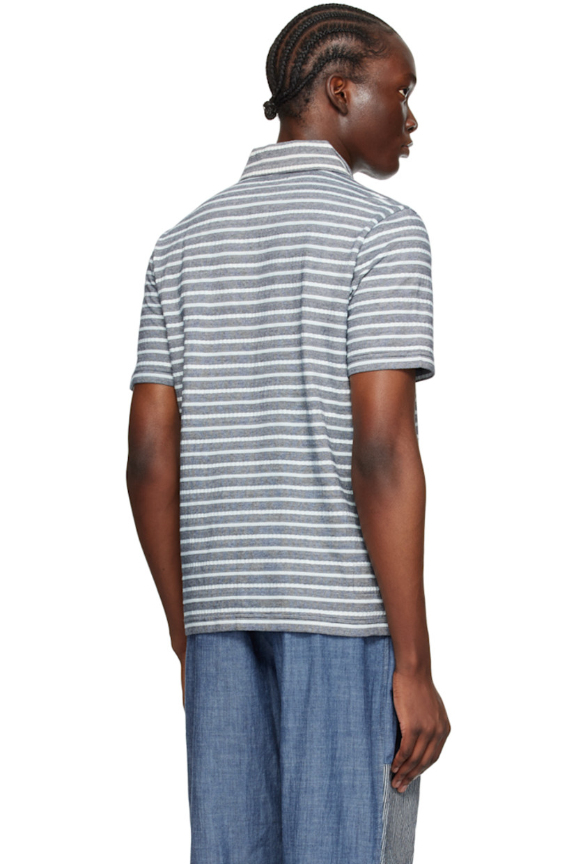 Knit and purl knit cotton polo. Jacquard stripes throughout.

· Spread collar
· Two-button placket
· Patch pocket 
· Vented side seams

Supplier color: Indigo