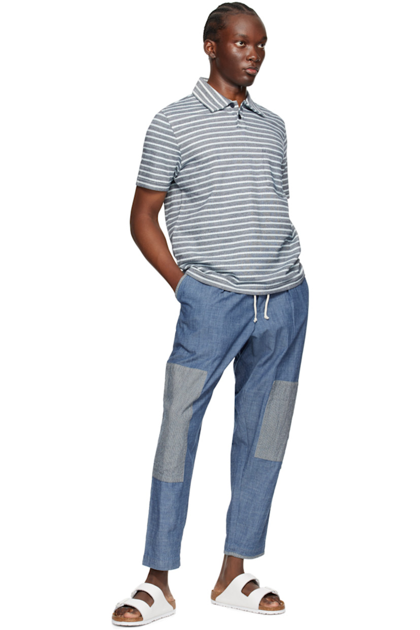 Knit and purl knit cotton polo. Jacquard stripes throughout.

· Spread collar
· Two-button placket
· Patch pocket 
· Vented side seams

Supplier color: Indigo