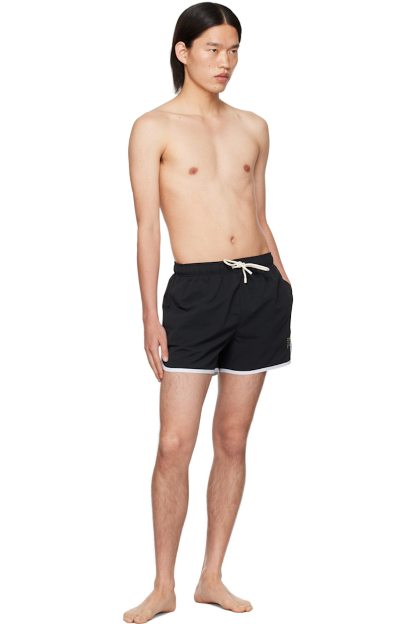 Polyester taffeta swim shorts.

· Drawstring at elasticized waistband
· Two-pocket styling
· Logo embroidered at front
· Piping at cuffs
· Integrated mesh shorts-style underlay

Supplier color: Black/Off white