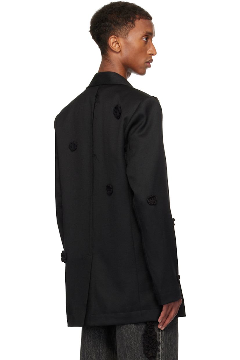 Wool drill blazer. Hand-woven cotton floral accents throughout.

· Notched lapel
· Button closure
· Welt pocket and flap pockets
· Padded shoulders
· Raw edge at sleeves and back
· Central vent at back hem
· Welt pockets at interior
· Full cupro satin lining

Supplier color: Black