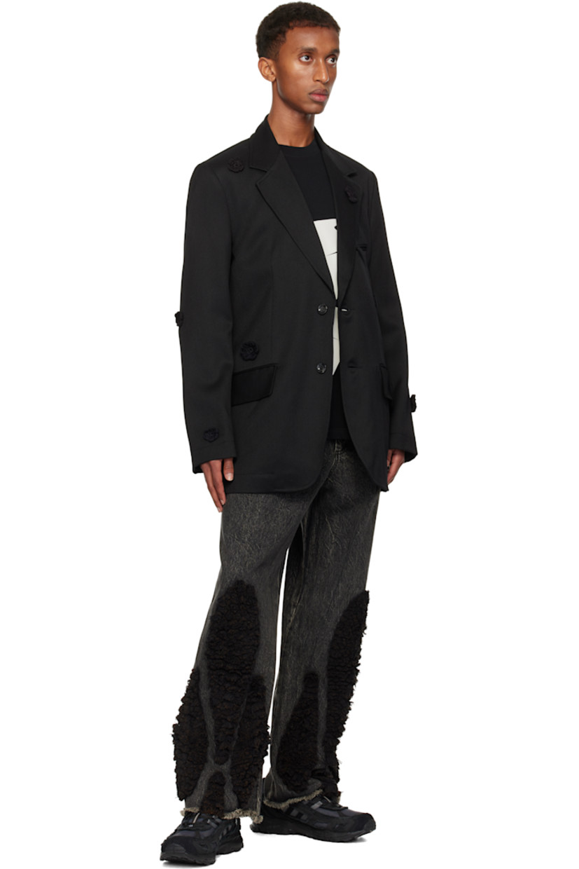 Wool drill blazer. Hand-woven cotton floral accents throughout.

· Notched lapel
· Button closure
· Welt pocket and flap pockets
· Padded shoulders
· Raw edge at sleeves and back
· Central vent at back hem
· Welt pockets at interior
· Full cupro satin lining

Supplier color: Black