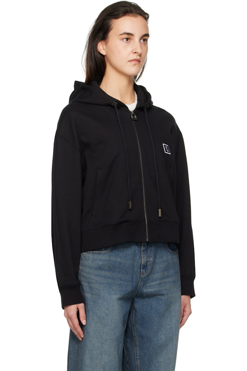 French terry hoodie.

· Drawstring at hood
· Zip closure
· Embroidered logo patch at chest
· Welt pockets
· Rib-knit hem and cuffs
· Dropped shoulders
· Logo hardware at back collar
· Logo printed at back

Supplier color: Black