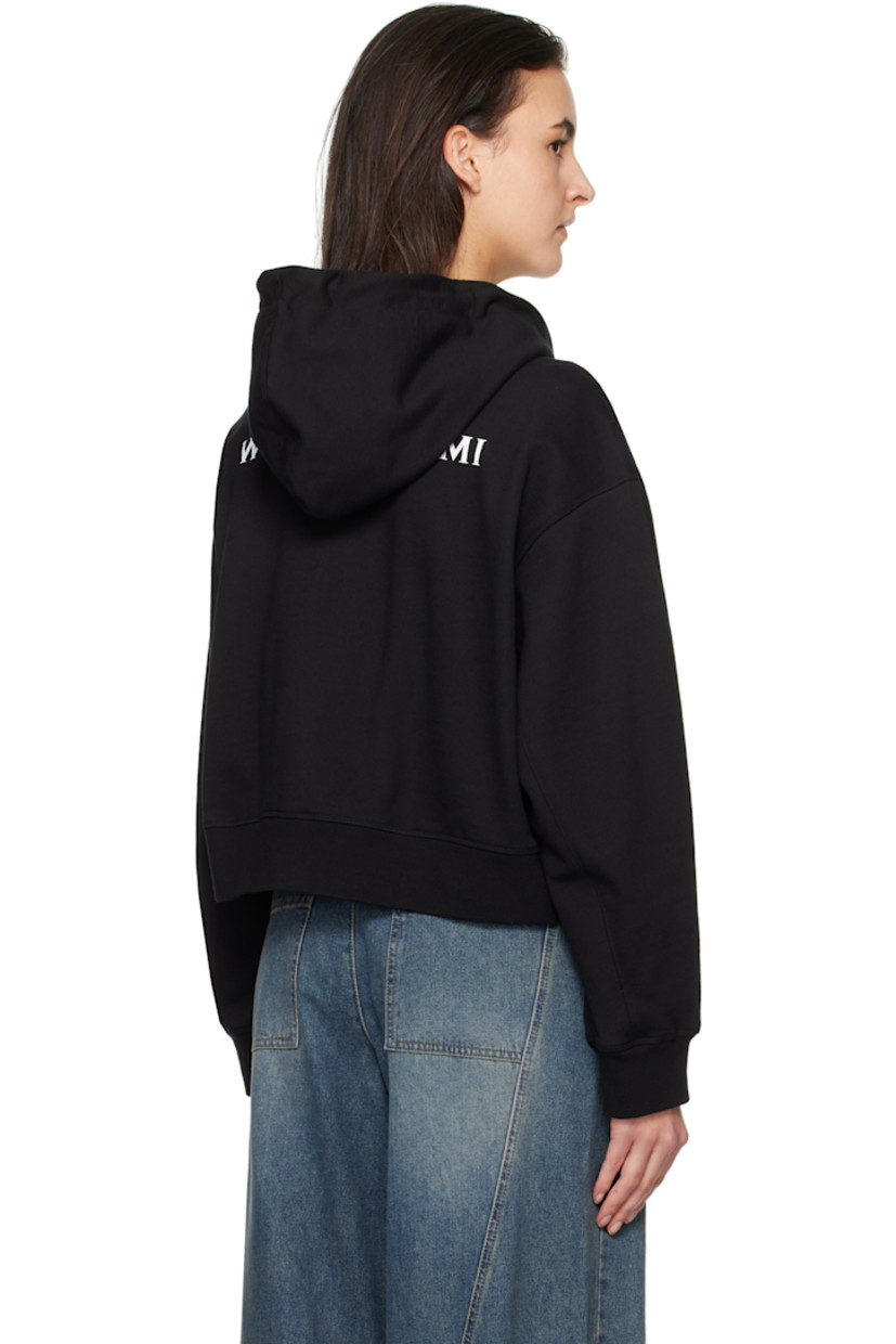 French terry hoodie.

· Drawstring at hood
· Zip closure
· Embroidered logo patch at chest
· Welt pockets
· Rib-knit hem and cuffs
· Dropped shoulders
· Logo hardware at back collar
· Logo printed at back

Supplier color: Black