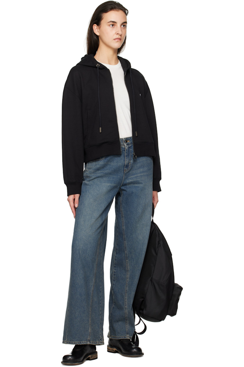French terry hoodie.

· Drawstring at hood
· Zip closure
· Embroidered logo patch at chest
· Welt pockets
· Rib-knit hem and cuffs
· Dropped shoulders
· Logo hardware at back collar
· Logo printed at back

Supplier color: Black