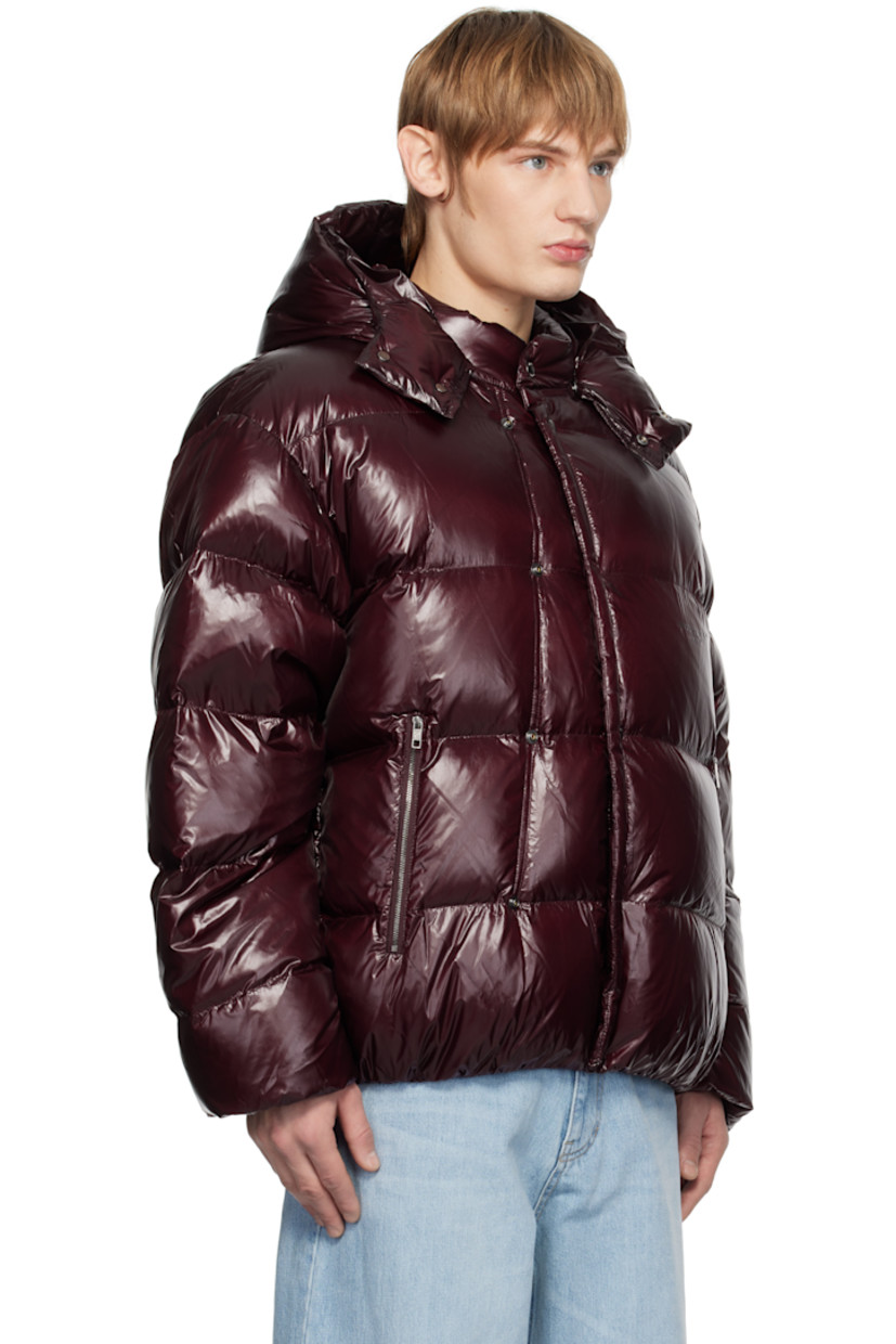 Down-filled and quilted nylon laqué jacket.

· Press-stud throat guard at detachable hood
· Stand collar
· Press-stud closure
· Logo stamp at chest
· Zip pockets
· Elasticized hem and cuffs
· Logo hardware at back
· Welt pockets at interior
· Full satin lining
· Logo-engraved silver-tone hardware

Supplier color: Red

Fill: 90% goose down, 10% goose feather.