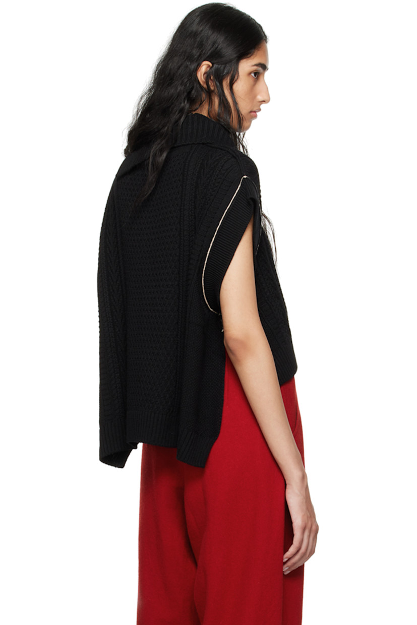 Aran knit wool- and nylon-blend vest.

· Rib knit foldover turtleneck, hem, and armscyes
· Droptail hem
· Vented side seams
· Contrast stitching in white

Supplier color: Black
