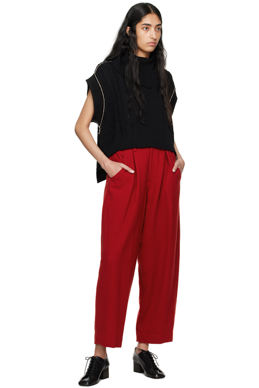 Aran knit wool- and nylon-blend vest.

· Rib knit foldover turtleneck, hem, and armscyes
· Droptail hem
· Vented side seams
· Contrast stitching in white

Supplier color: Black