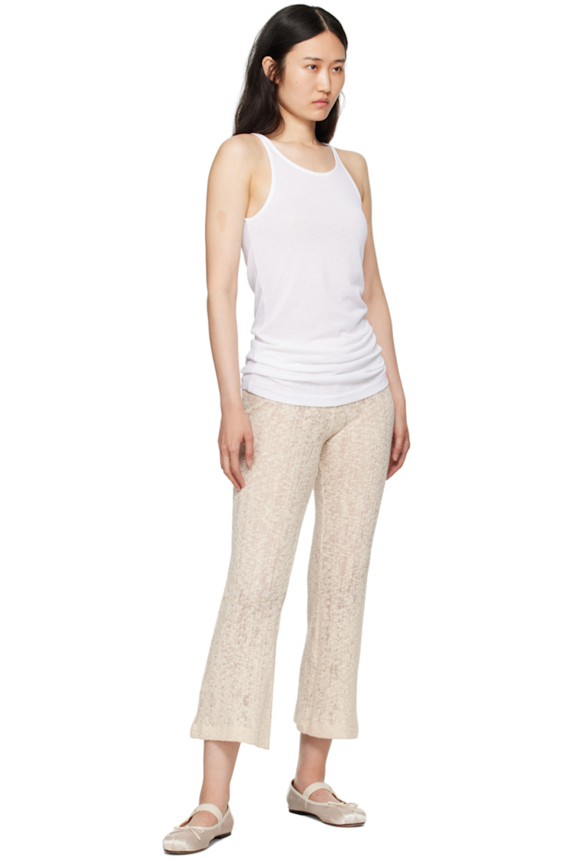 Semi-sheer lightweight textured knit organic cotton-blend lounge pants. 

· Elasticized waistband
· Cropped legs 
· Flared cuffs

Supplier color: Off white