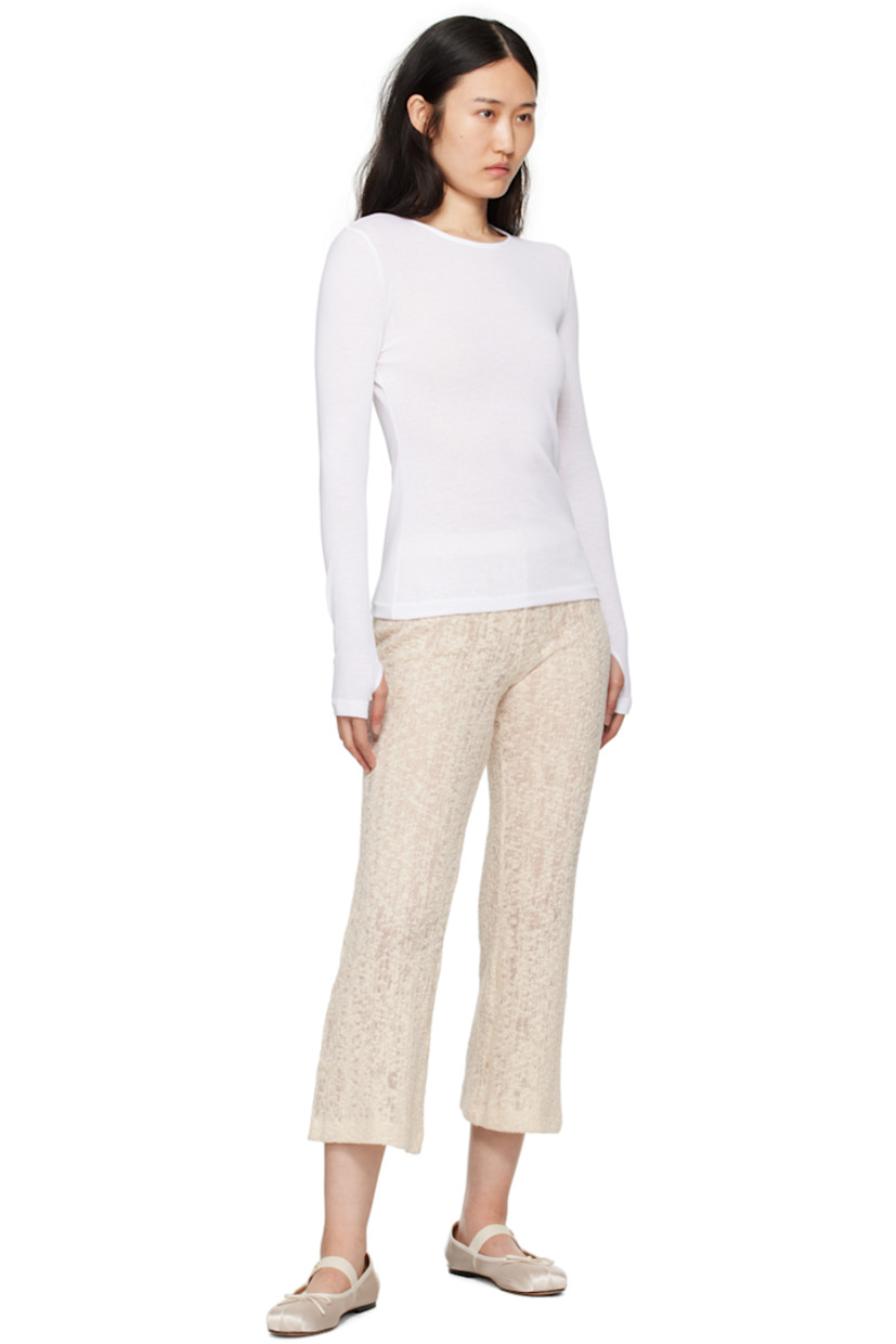 Semi-sheer knit organic cotton T-shirt. 

· Crewneck
· Thumbhole at cuffs
· Central seam at back 

Supplier color: White