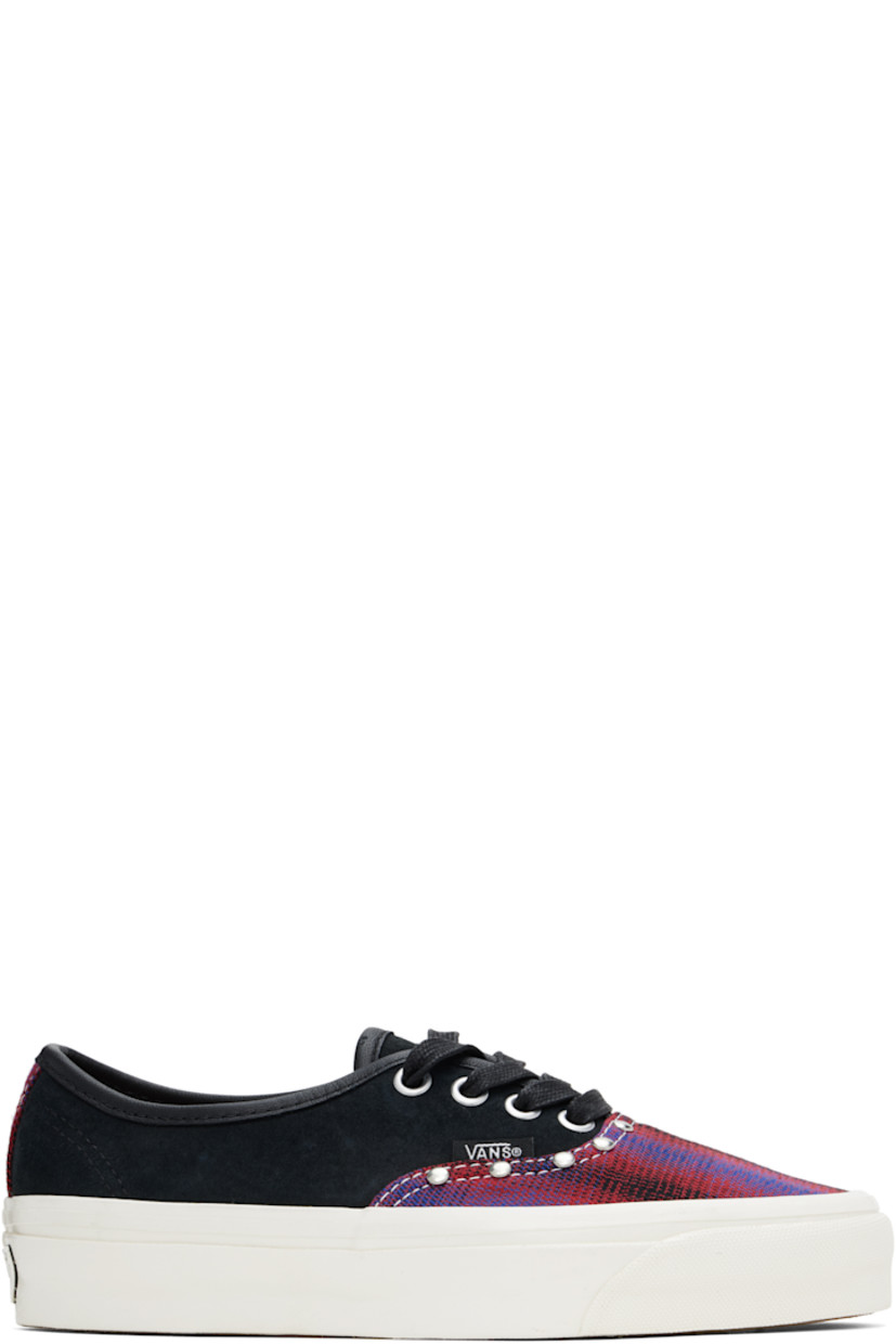 Low-top suede and canvas sneakers in black and purple. Check pattern throughout.

· Lace-up closure
· Stud detailing at vamp 
· Logo flag at outer side
· Padded Sola ADC foam footbed
· Canvas lining
· Rubberized logo patch at heel
· Treaded rubber sole

Supplier color: Prep plaid/Chili pepper red