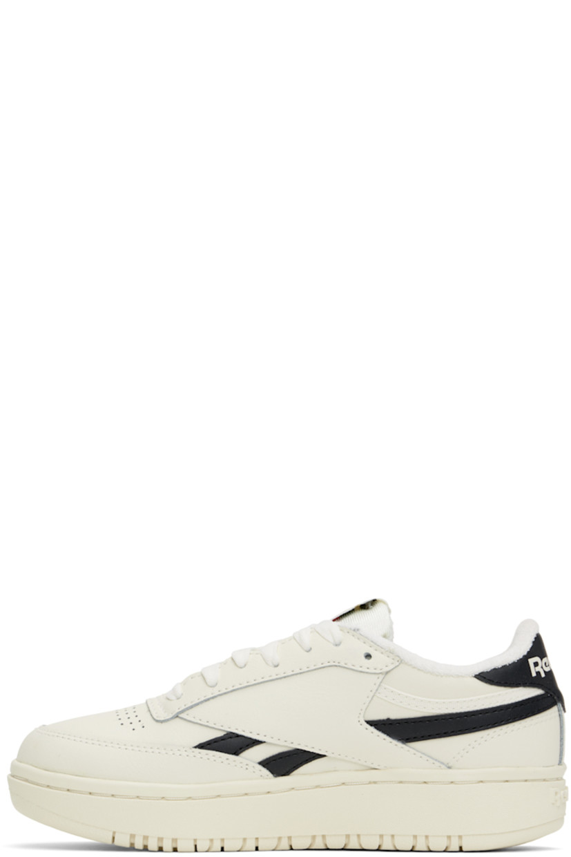 Low-top grained leather sneakers in off-white and black.

· Perforated detailing at toe
· Lace-up closure
· Logo patch at padded tongue
· Padded collar
· Inset logo patch at outer side
· Signature stripes at sides
· Logo printed at heel tab
· Logo embossed at heel
· Treaded rubber sole

Supplier color: Chalk/Core Blk/Chalk