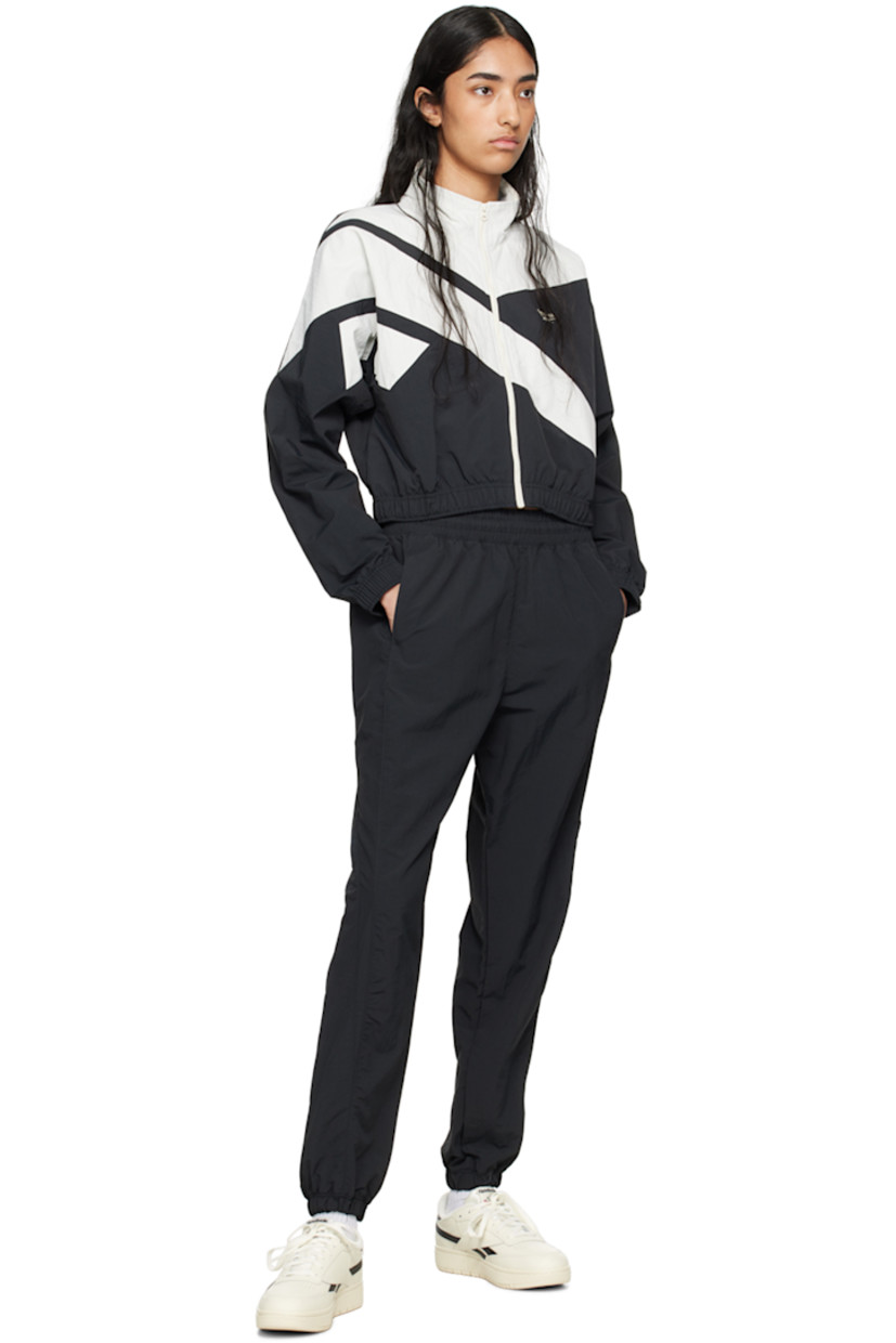 Low-top grained leather sneakers in off-white and black.

· Perforated detailing at toe
· Lace-up closure
· Logo patch at padded tongue
· Padded collar
· Inset logo patch at outer side
· Signature stripes at sides
· Logo printed at heel tab
· Logo embossed at heel
· Treaded rubber sole

Supplier color: Chalk/Core Blk/Chalk
