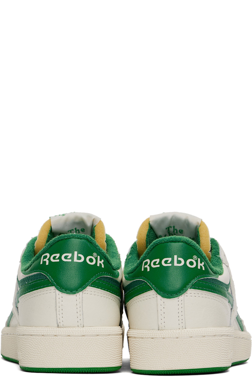 Low-top grained leather sneakers in off-white and green.

· Perforated detailing at toe
· Lace-up closure
· Logo patch at padded tongue
· Padded collar
· Inset logo patch at outer side
· Signature stripes at sides
· Logo embroidered at heel tab
· Terrycloth lining
· Treaded rubber sole

Supplier color: Chalk/Papwht/Glegrn