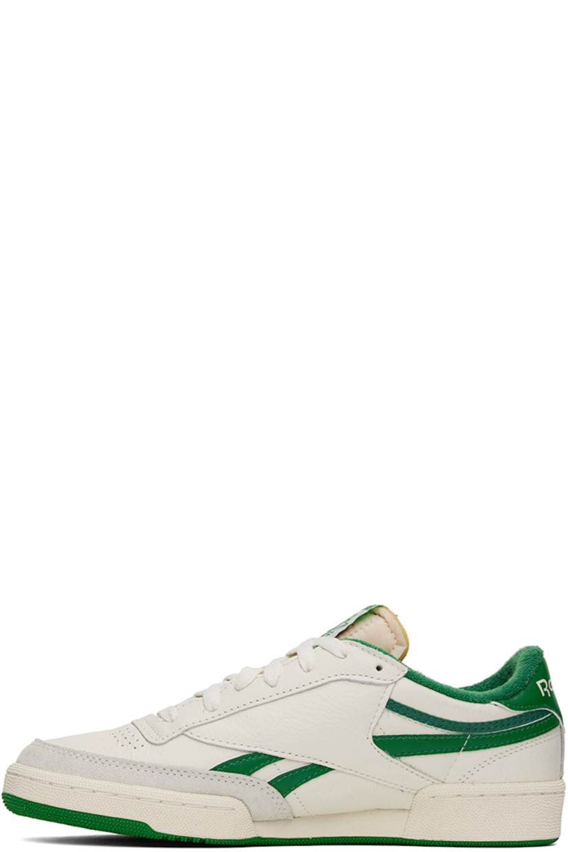 Low-top grained leather sneakers in off-white and green.

· Perforated detailing at toe
· Lace-up closure
· Logo patch at padded tongue
· Padded collar
· Inset logo patch at outer side
· Signature stripes at sides
· Logo embroidered at heel tab
· Terrycloth lining
· Treaded rubber sole

Supplier color: Chalk/Papwht/Glegrn