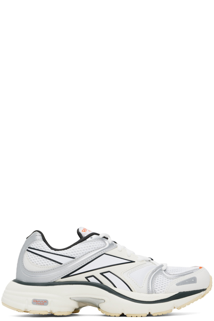 Low-top mesh and buffed faux-leather sneakers in white, black, and silver tone.

· Lace-up closure
· Logo patch at padded tongue
· Padded collar
· Rubberized trim at sides
· Mesh lining
· DMX foam rubber midsole
· Treaded rubber sole

Supplier color: Chalk/Grey/White