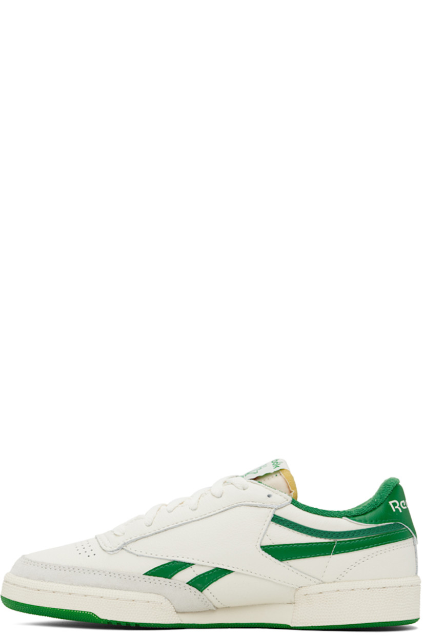 Low-top grained leather sneakers in off-white and green.

· Suede trim at toe
· Perforated detailing at vamp
· Lace-up closure
· Logo patch at padded tongue
· Padded collar
· Inset logo patch at outer side
· Signature stripes at sides
· Logo embossed at heel tab
· Terrycloth lining
· Textured rubber midsole
· Treaded rubber sole

Supplier color: Chalk/Papwht/Glegreen
