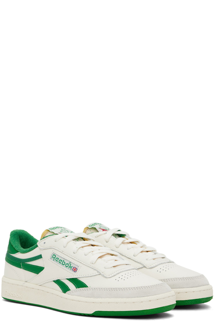 Low-top grained leather sneakers in off-white and green.

· Suede trim at toe
· Perforated detailing at vamp
· Lace-up closure
· Logo patch at padded tongue
· Padded collar
· Inset logo patch at outer side
· Signature stripes at sides
· Logo embossed at heel tab
· Terrycloth lining
· Textured rubber midsole
· Treaded rubber sole

Supplier color: Chalk/Papwht/Glegreen