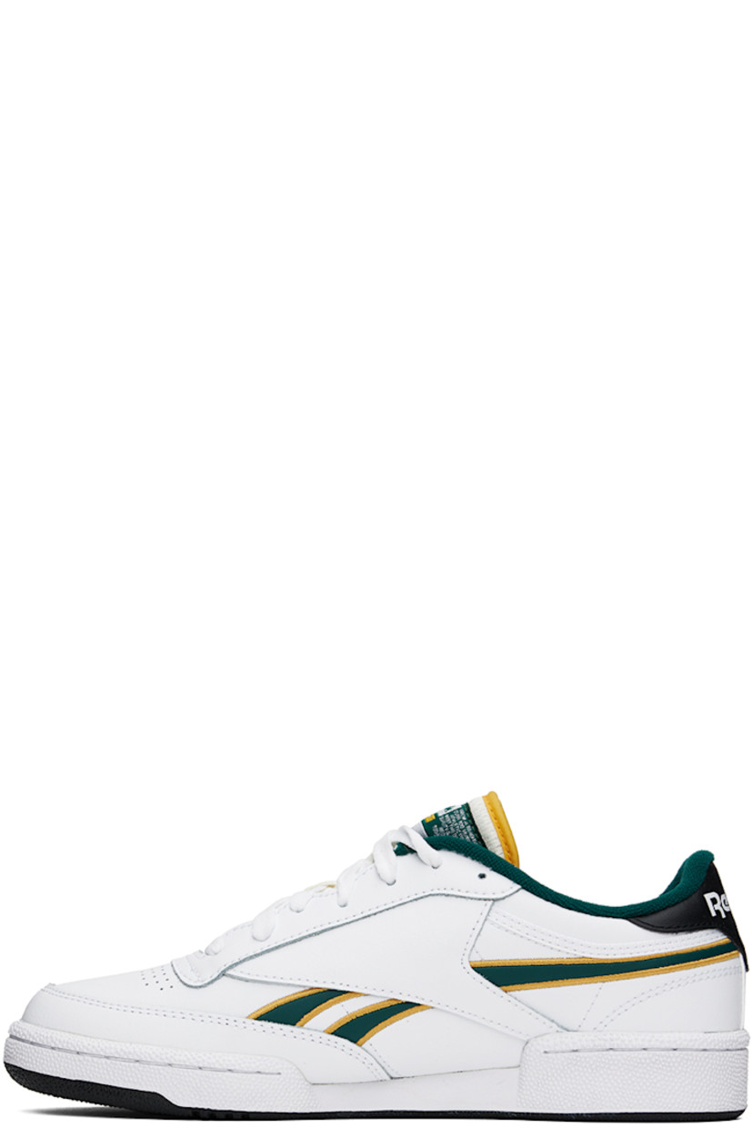 Low-top buffed leather sneakers in white and black.

· Perforated detailing at toe
· Lace-up closure
· Logo patch at padded tongue
· Padded collar
· Inset logo patch at outer side
· Signature stripes at sides
· Logo printed at heel tab
· Terrycloth lining
· Treaded rubber sole

Supplier color: White/Fiercegold/Clg