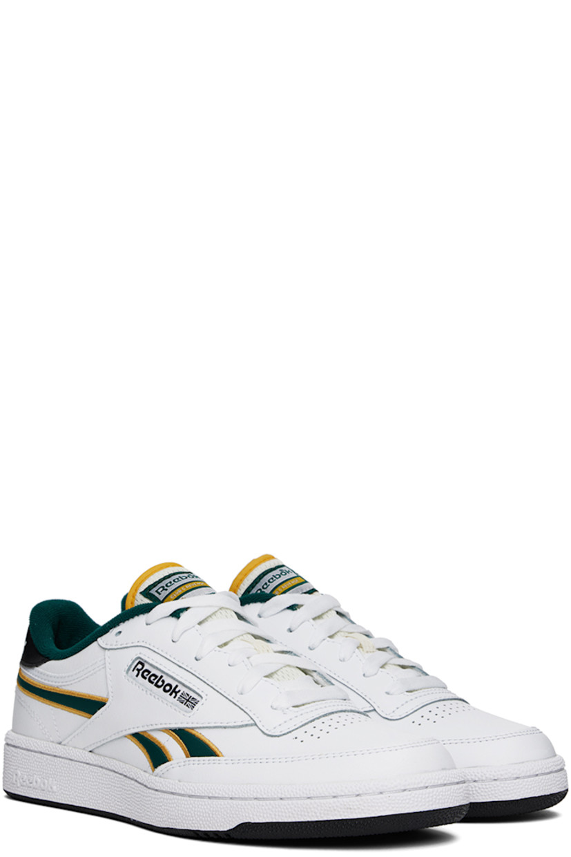Low-top buffed leather sneakers in white and black.

· Perforated detailing at toe
· Lace-up closure
· Logo patch at padded tongue
· Padded collar
· Inset logo patch at outer side
· Signature stripes at sides
· Logo printed at heel tab
· Terrycloth lining
· Treaded rubber sole

Supplier color: White/Fiercegold/Clg