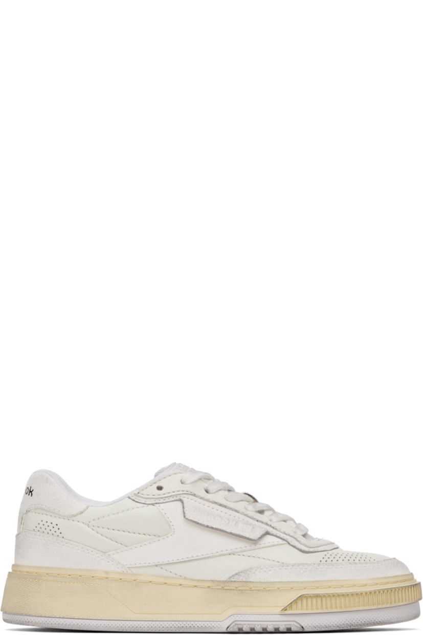 Low-top buffed leather sneakers in off-white. 

· Perforated detailing at toe and heel
· Lace-up closure
· Logo embossed at padded tongue
· Padded collar
· Logo flag at outer side
· Logo printed at heel tab
· Treaded rubber sole

Supplier color: Wax moon white