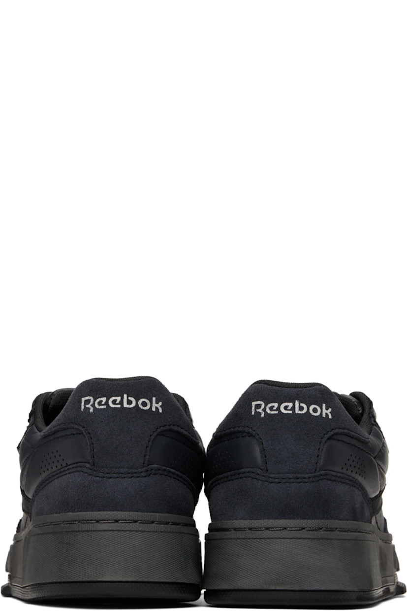 Low-top buffed leather sneakers in black. 

· Perforated detailing at toe and heel
· Lace-up closure
· Logo embossed at padded tongue
· Padded collar
· Logo flag at outer side
· Logo printed at heel tab
· Treaded rubber sole

Supplier color: Wax black
