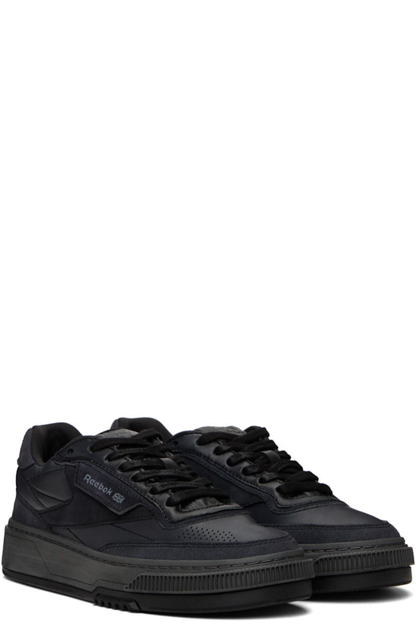 Low-top buffed leather sneakers in black. 

· Perforated detailing at toe and heel
· Lace-up closure
· Logo embossed at padded tongue
· Padded collar
· Logo flag at outer side
· Logo printed at heel tab
· Treaded rubber sole

Supplier color: Wax black
