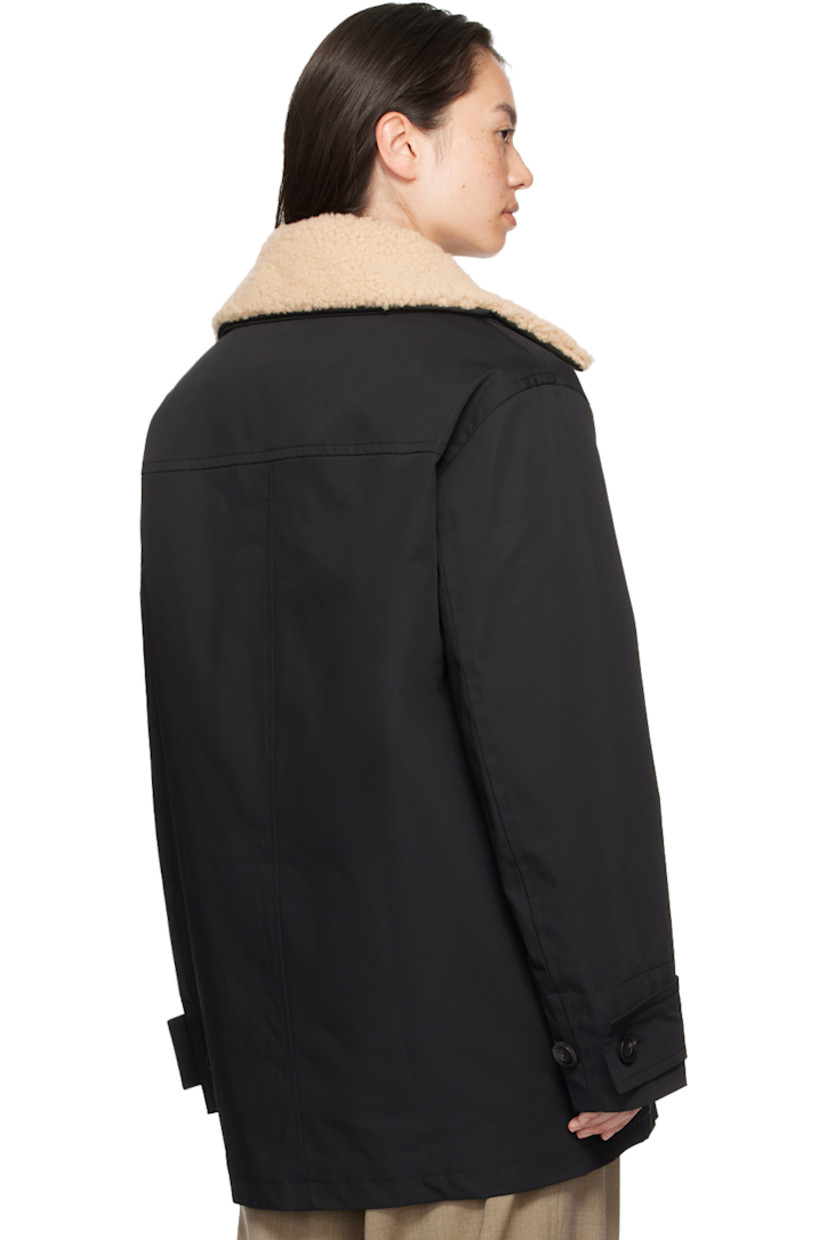 Nylon drill jacket. 

· Detachable shearling trim at spread collar
· Button closure
· Welt pockets at chest
· Rubberized logo patch at front
· Flap pockets
· Adjustable button tab at cuffs
· Welt pocket at interior 
· Full quilted satin lining 

Supplier color: Black/Ivory