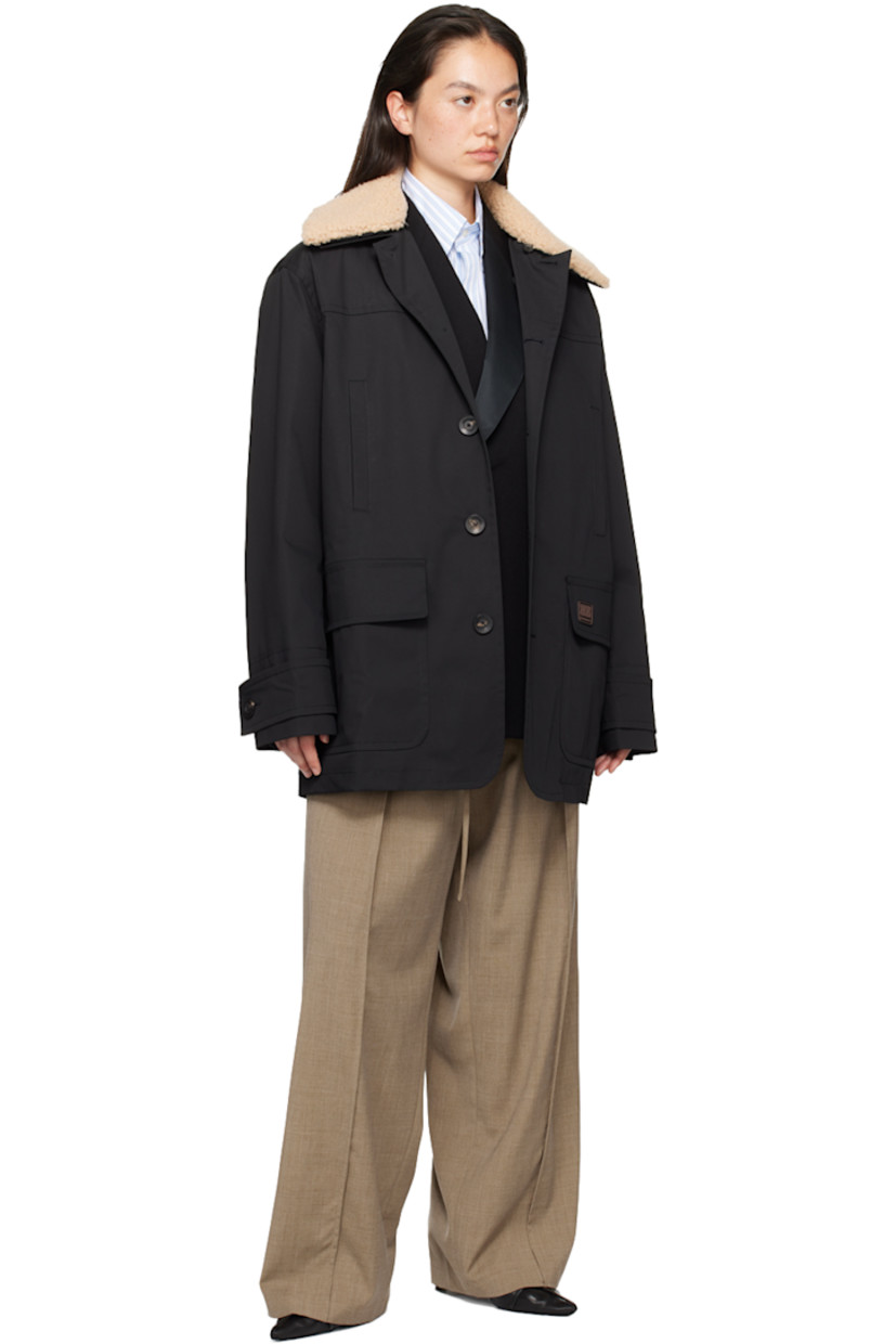 Nylon drill jacket. 

· Detachable shearling trim at spread collar
· Button closure
· Welt pockets at chest
· Rubberized logo patch at front
· Flap pockets
· Adjustable button tab at cuffs
· Welt pocket at interior 
· Full quilted satin lining 

Supplier color: Black/Ivory
