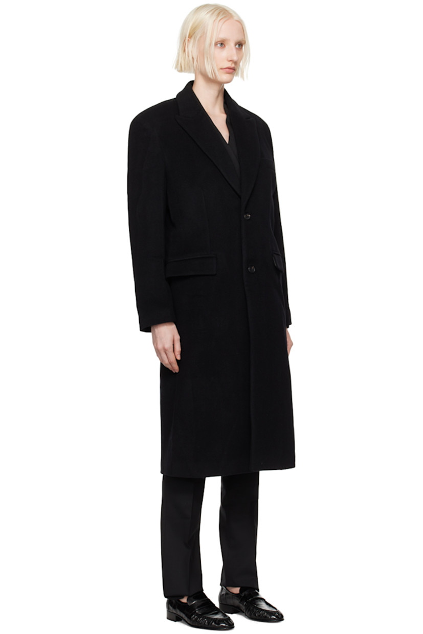 Oversized wool-blend melton coat. 

· Peaked lapel
· Button closure
· Welt pocket
· Flap pockets 
· Padded shoulders
· Logo patch at cuff
· Central vent at back hem
· Welt pocket at interior
· Full viscose satin lining 

Supplier color: Black