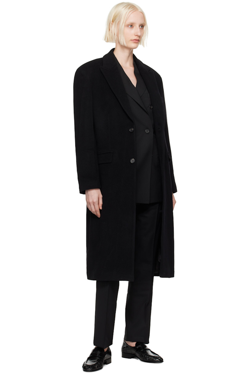 Oversized wool-blend melton coat. 

· Peaked lapel
· Button closure
· Welt pocket
· Flap pockets 
· Padded shoulders
· Logo patch at cuff
· Central vent at back hem
· Welt pocket at interior
· Full viscose satin lining 

Supplier color: Black