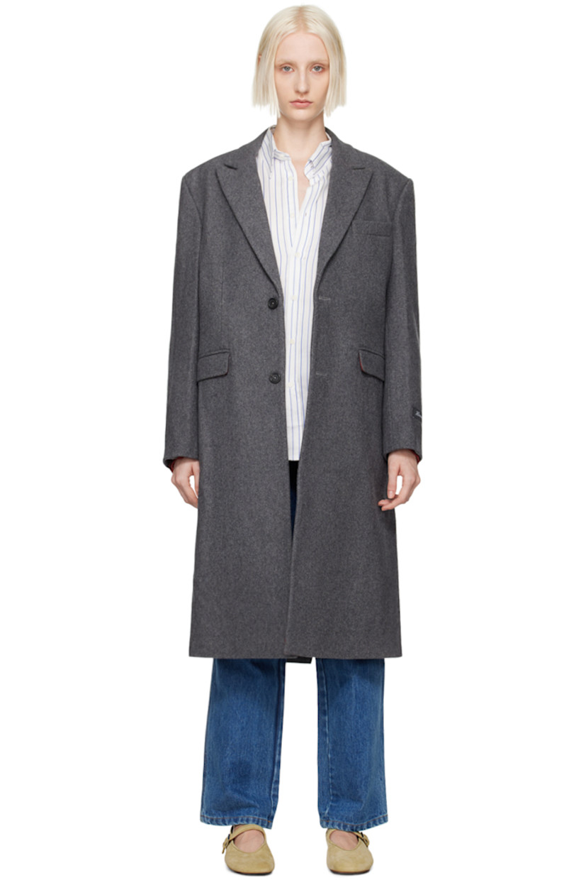 Wool-blend melton coat. 

· Peaked lapel
· Button closure
· Welt pocket 
· Flap pockets 
· Padded shoulders
· Logo patch at cuff
· Central vent at back hem 
· Welt pocket at interior
· Full viscose satin lining 

Supplier color: Charcoal
