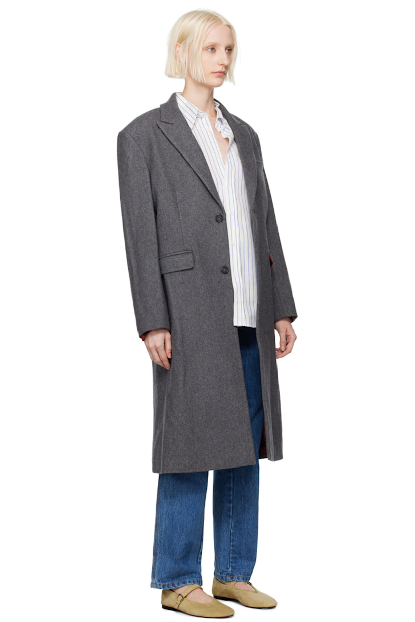 Wool-blend melton coat. 

· Peaked lapel
· Button closure
· Welt pocket 
· Flap pockets 
· Padded shoulders
· Logo patch at cuff
· Central vent at back hem 
· Welt pocket at interior
· Full viscose satin lining 

Supplier color: Charcoal