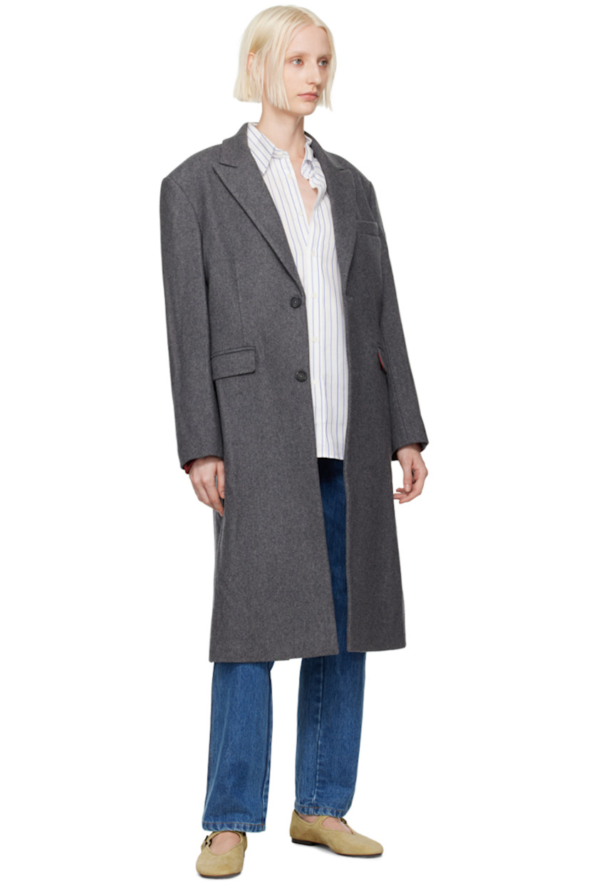 Wool-blend melton coat. 

· Peaked lapel
· Button closure
· Welt pocket 
· Flap pockets 
· Padded shoulders
· Logo patch at cuff
· Central vent at back hem 
· Welt pocket at interior
· Full viscose satin lining 

Supplier color: Charcoal