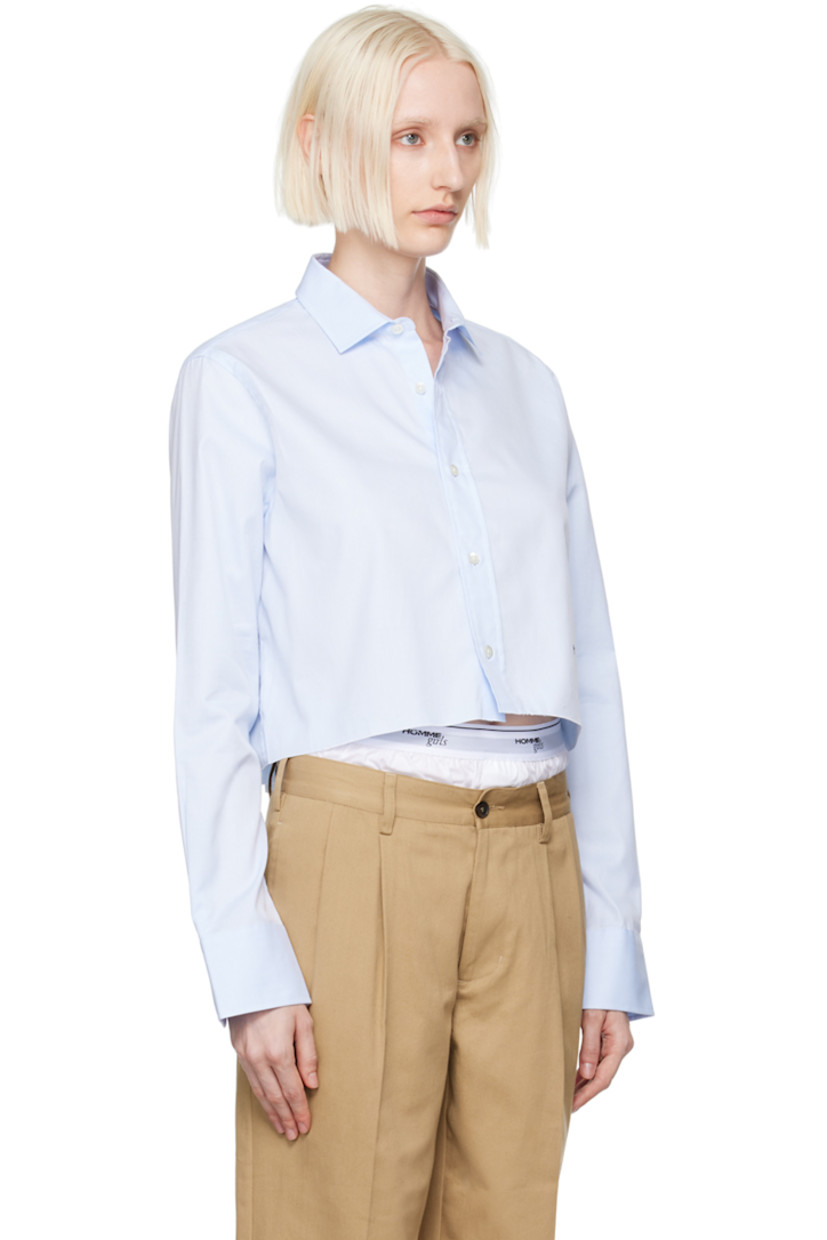 Cotton twill shirt.

· Spread collar
· Button closure
· Logo embroidered at front
· Raw edge at cropped hem
· Adjustable single-button barrel cuffs
· Box pleat at back yoke

Supplier color: Chambray blue