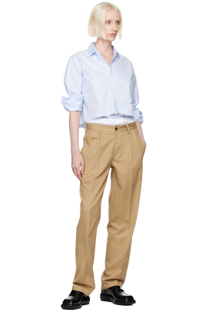 Cotton twill shirt.

· Spread collar
· Button closure
· Logo embroidered at front
· Raw edge at cropped hem
· Adjustable single-button barrel cuffs
· Box pleat at back yoke

Supplier color: Chambray blue